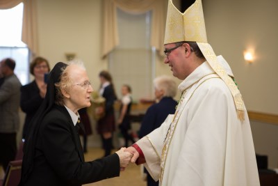 CSJ Sister greeting His Excellency Most Reverend Bishop Miehm